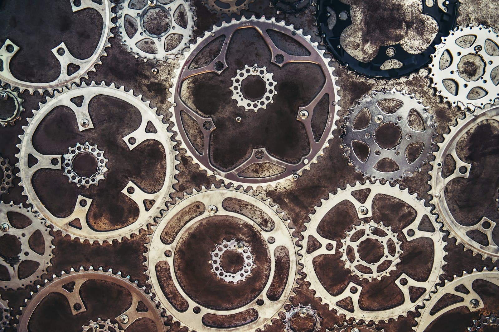 Close-up of a sophisticated mechanical gear assembly made of translucent materials and illuminated from within by a soft blue light.